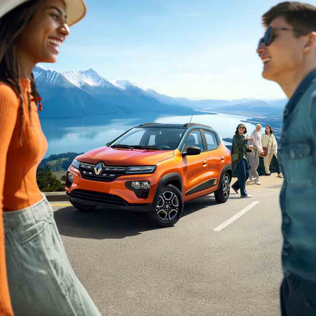 Renault Kwid naranja de alquiler en San Carlos de Bariloche, con viajeros disfrutando del paisaje patagónico y el lago Nahuel Huapi al fondo. Servicio Rent a Car de Diversidad. Turismo Activo & de Naturaleza.